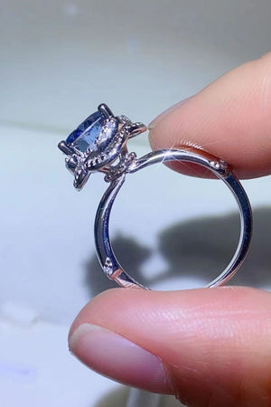 Blue moissanite halo cocktail ring with pave band detail.