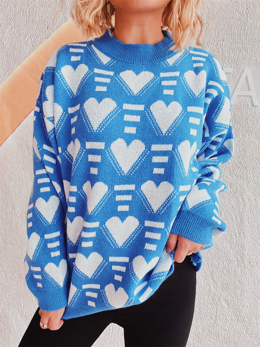 Blue acrylic knit jumper with white geometric heart pattern and mock neck.