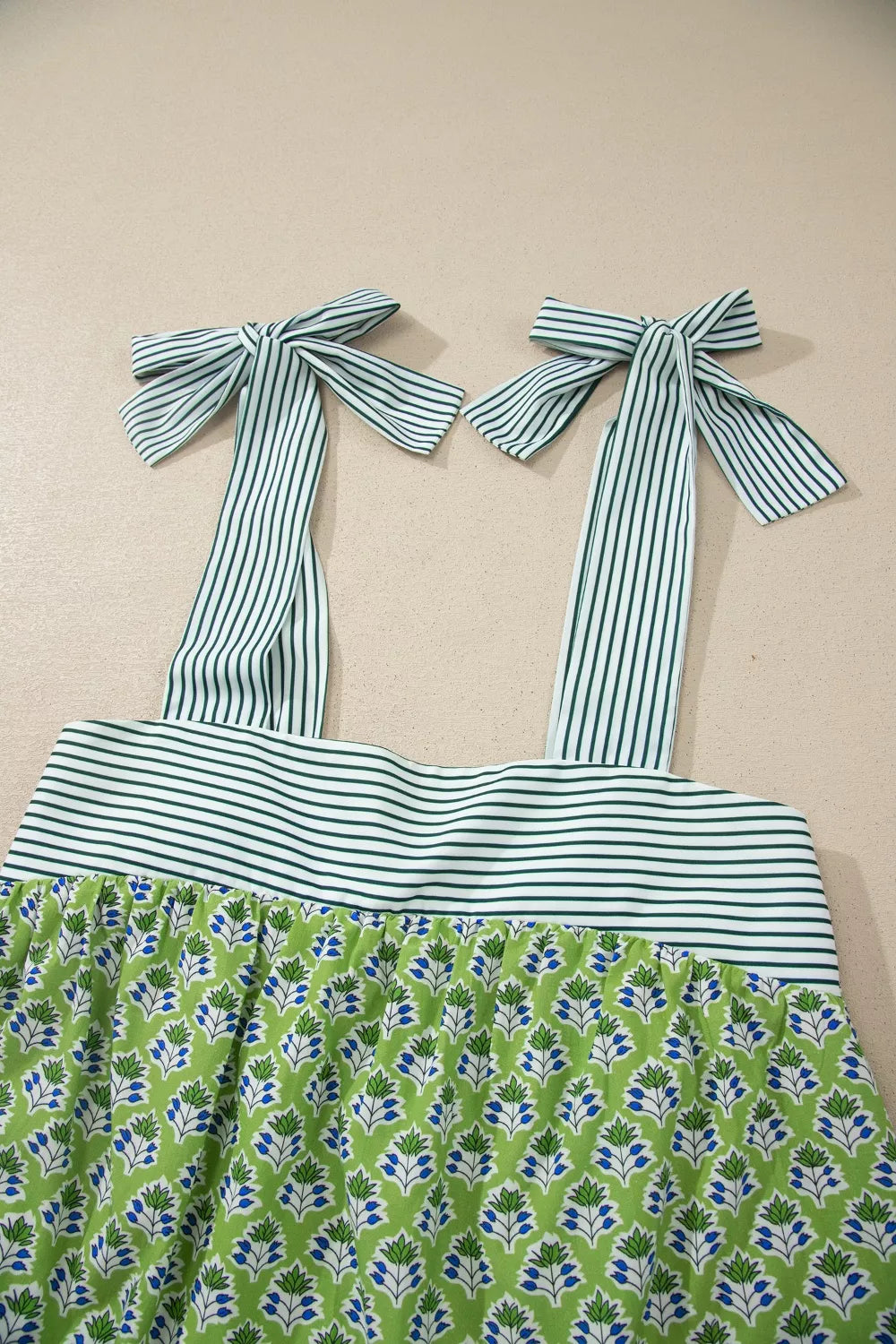 Floral tie-strap tank top with square neckline, green and blue print, cotton, green and white stripe bodice and straps.