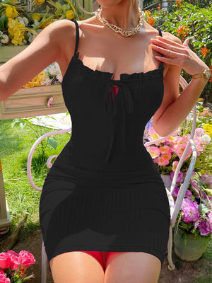 Black ribbed mini dress with spaghetti straps and a tie-front neckline.