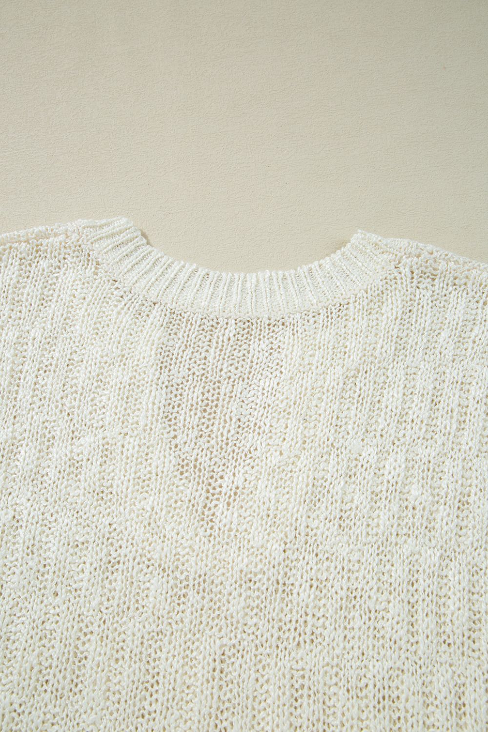 Textured knit V-neck shell top in beige acrylic with a subtle vertical rib pattern.