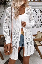 White openwork crochet duster cardigan with intricate floral patterns and a breezy, casual style.