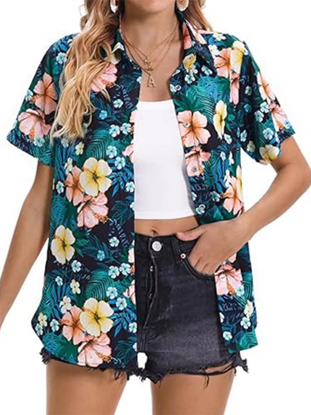 Tropical hibiscus print button-up shirt with short sleeves and a collar, styled open over a white tank top.