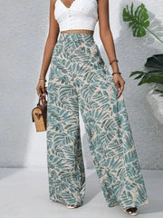 Tropical leaf print palazzo trousers in green and beige, 100% polyester, wide leg.