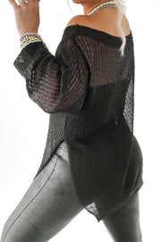 Black off-shoulder metallic knit top with long sleeves and side slits, styled with jewelry.