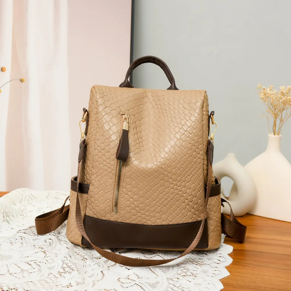 Tan woven faux leather convertible backpack with brown trim and zipper detail.