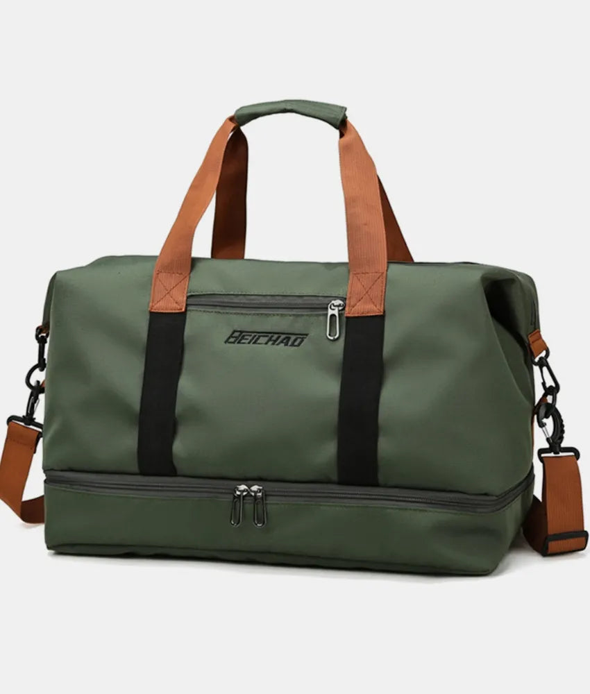 Green dual-compartment weekender bag with black and brown contrast straps and a zippered bottom compartment.
