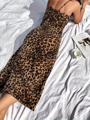Chic leopard print midi slip dress with adjustable spaghetti straps and a body-skimming fit.
