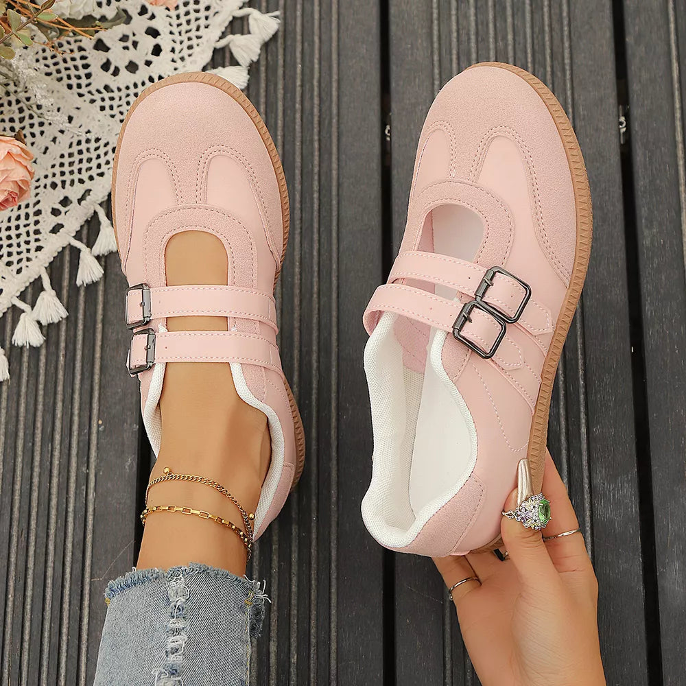 Pink buckle strap Mary Jane inspired sneakers with suede accents and double buckle closure.