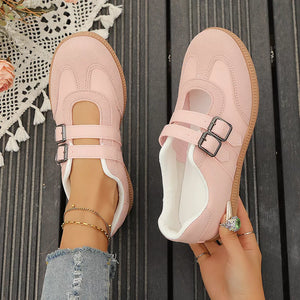 Pink buckle strap Mary Jane inspired sneakers with suede accents and double buckle closure.