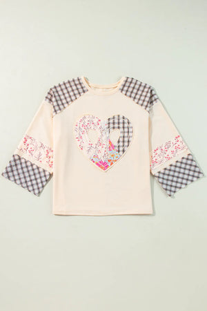 Patchwork heart raglan top in tan with plaid and floral details on sleeves and chest.