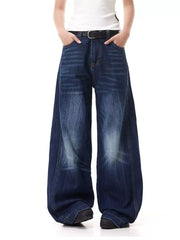 Belted wide leg jeans in washed denim with vertical stripe detail.