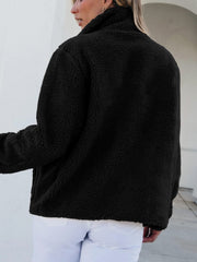 Black sherpa zip-up jacket with a stand-up collar and patch pockets.