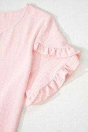 Blush pink polyester blouse with short ruffled sleeves and a crew neck.