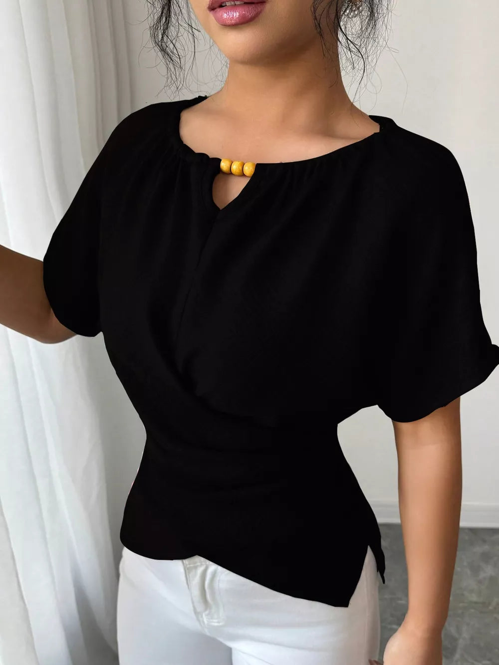 Black short sleeve maternity blouse with keyhole neckline and beaded accent