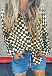 Olive and black checkered button-down shirt with a relaxed fit, styled with denim shorts.