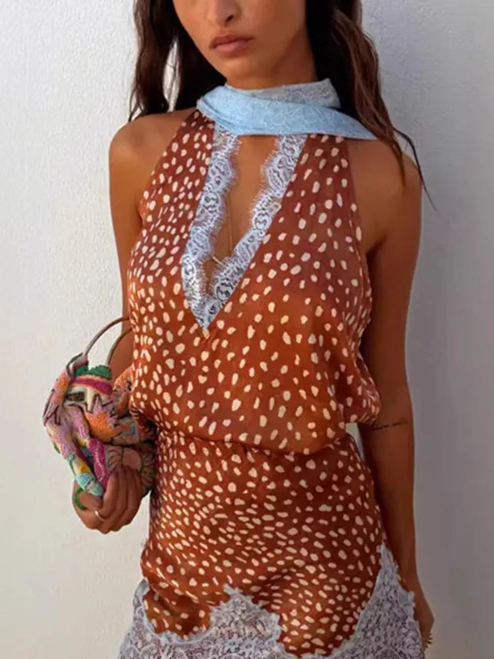 Brown polka dot halter top with lace trim and matching lace skirt.