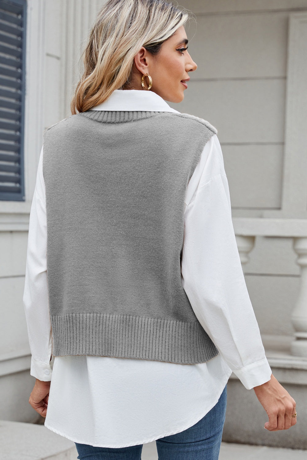 Gray cable knit diamond vest with ribbed hem, worn over a white collared shirt.