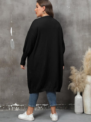Black oversized knit duster cardigan with patch pockets and ribbed cuffs.