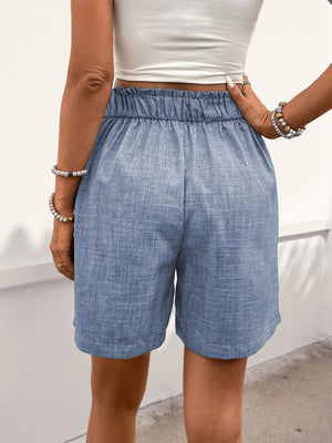 Light blue linen shorts with elastic waist and pleat front detail.