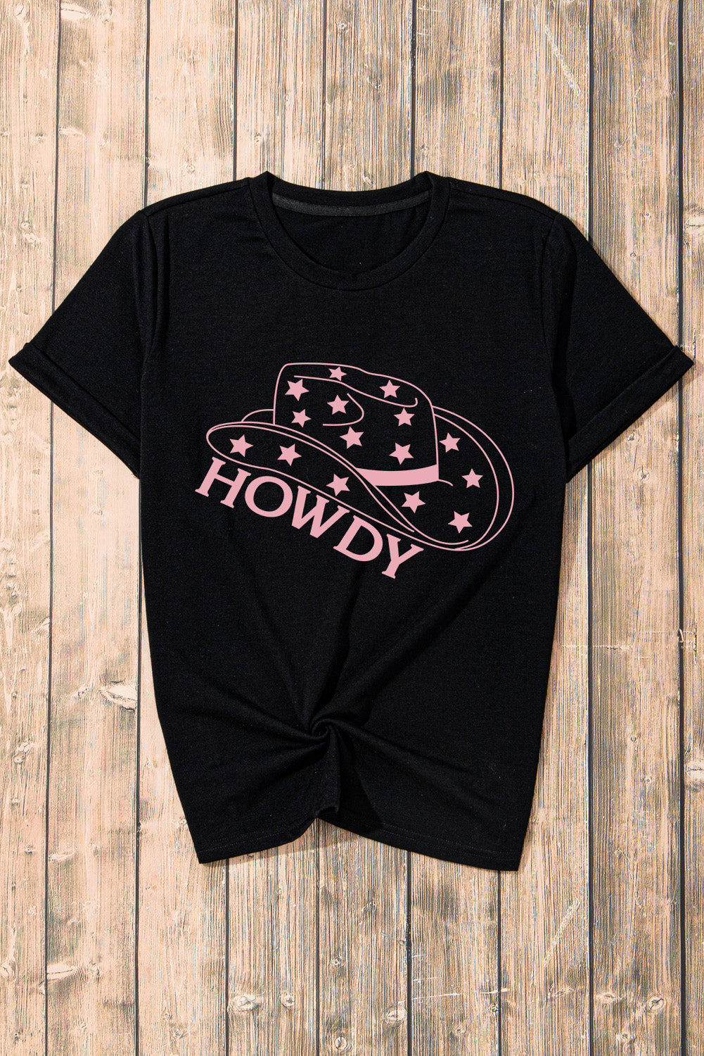 Black cotton t-shirt with rolled sleeves and a pink Howdy cowboy hat graphic.