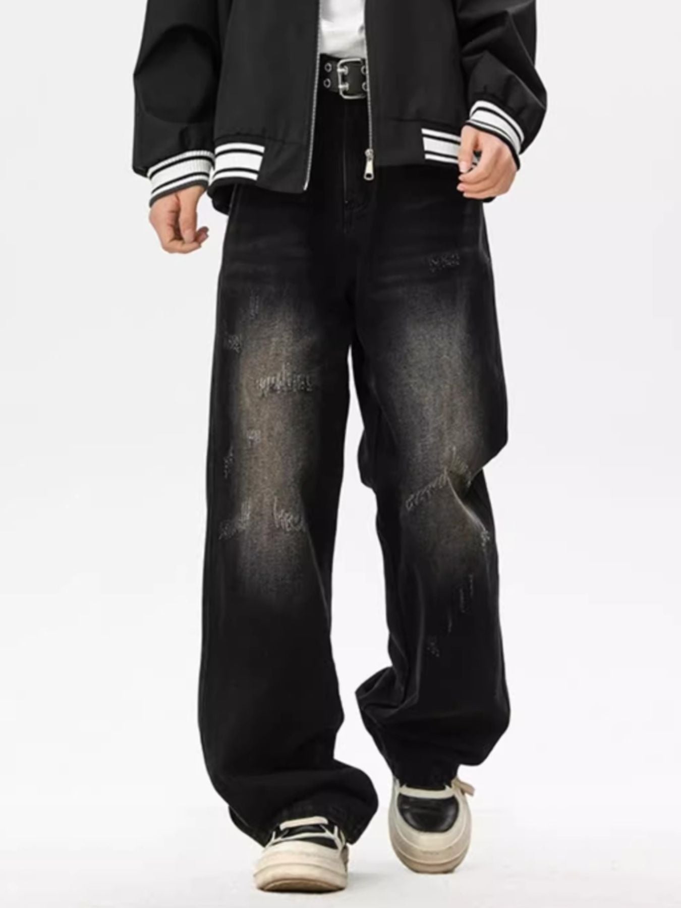 Distressed black wide leg jeans with a faded wash and ripped details.
