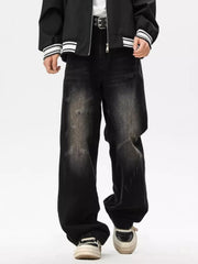 Distressed black wide leg jeans with a faded wash and ripped details.