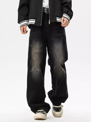 Distressed black wide leg jeans with a faded wash and ripped details.