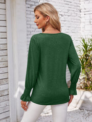 Dark green blouse with blouson sleeves and smocked cuffs.