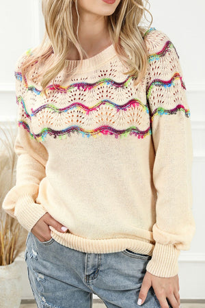 Cream acrylic knit sweater with colorful scallop detail and open knit yoke.