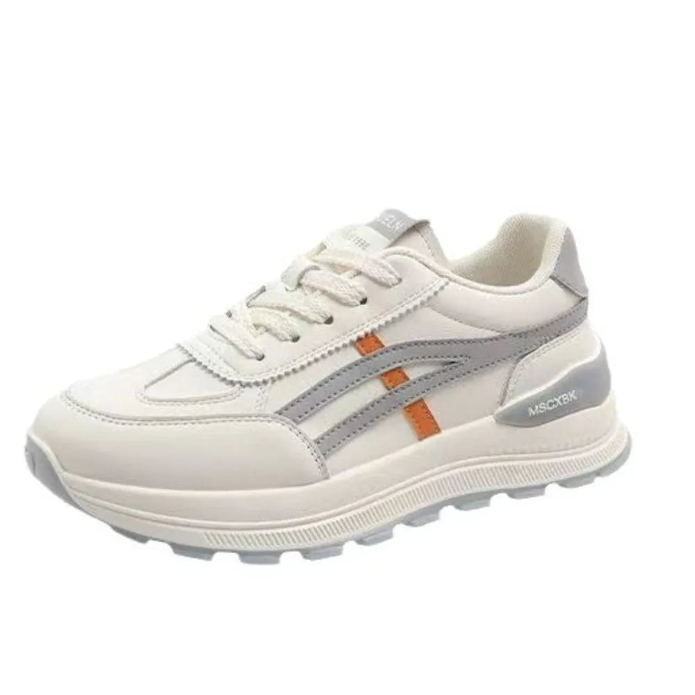 Retro platform sneakers in white with gray and orange contrast stripes and a chunky sole.