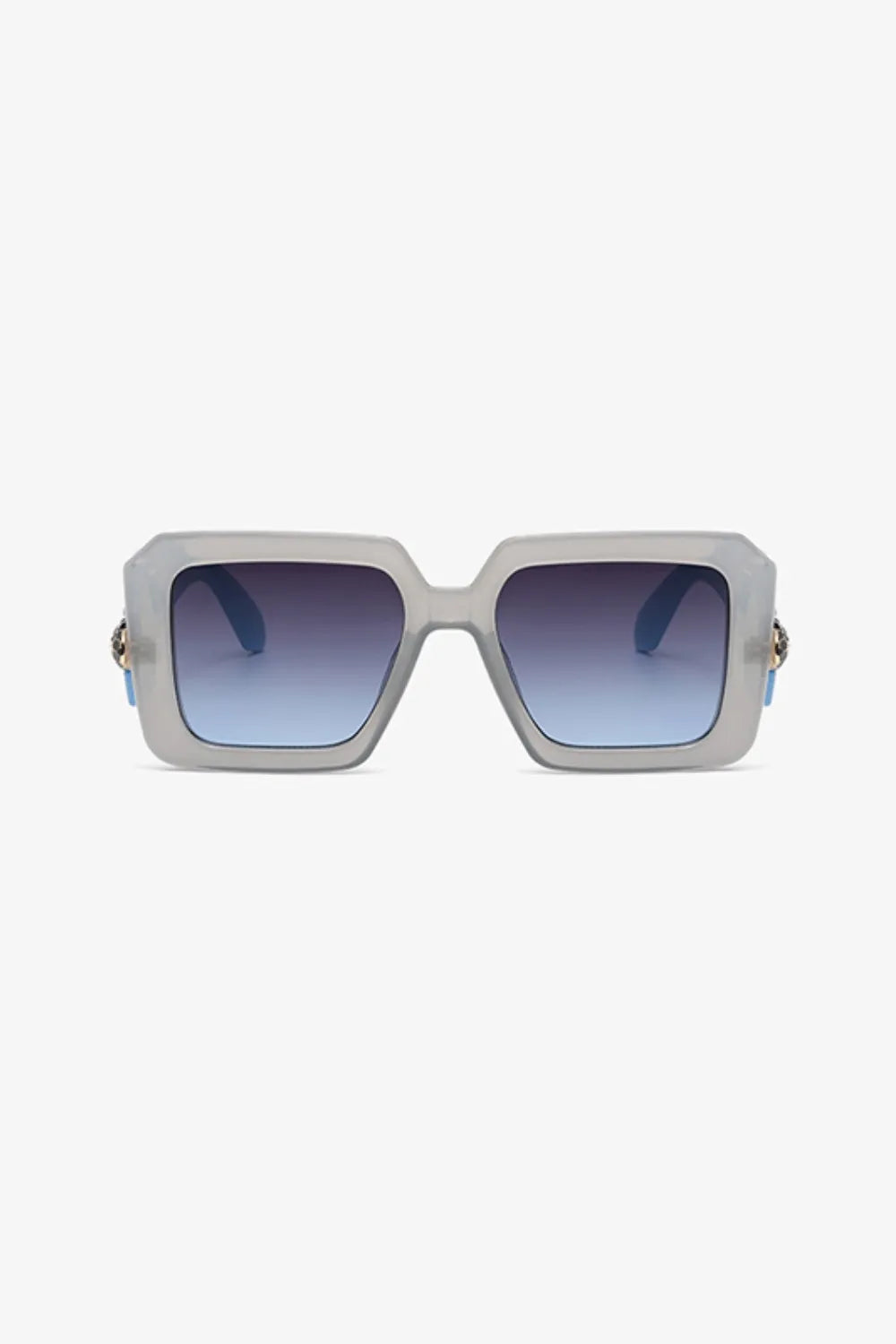 Geometric facet sunglasses in pastel blue with gradient lenses and gold embellishment detail.