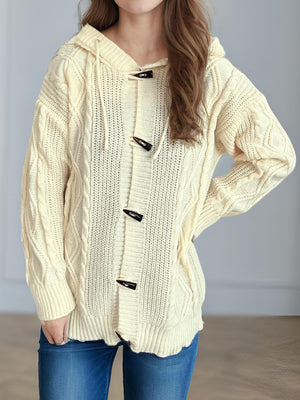 Beige cable knit hoodie with toggle buttons and drawstring hood.