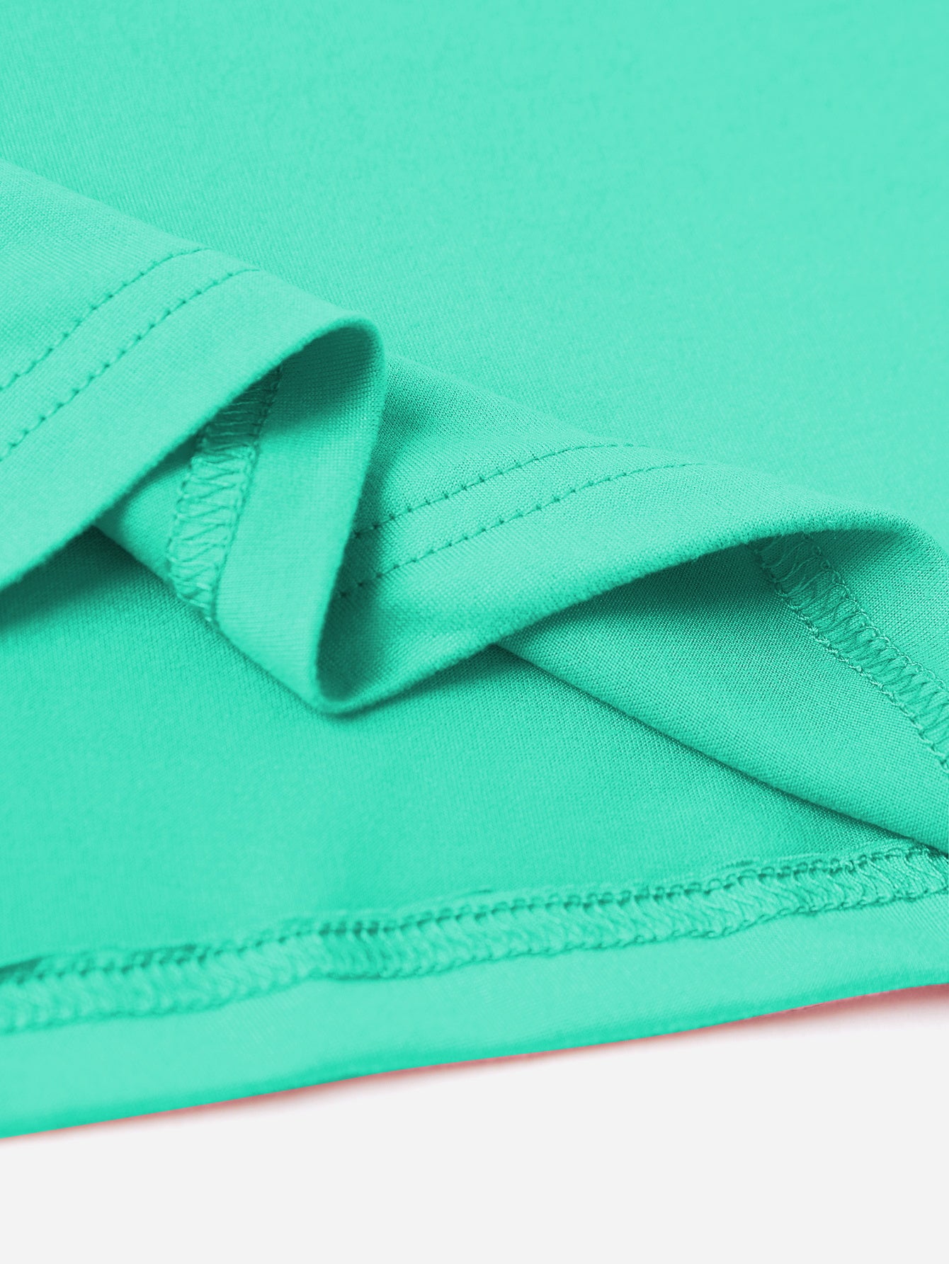 Aqua t-shirt detail showing hem stitching and fabric texture.