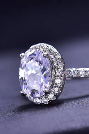 Halo oval diamond engagement ring in white with pave band.