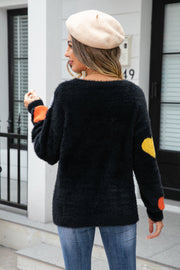 Black fluffy knit sweater with heart details on sleeves and back.