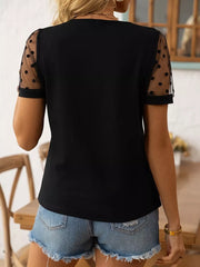 Black polka dot sheer sleeve t-shirt with crew neck and short sleeves.