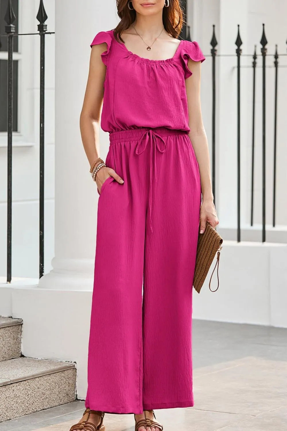 Hot Pink Textured Ruffle-Sleeve Drawstring Palazzo Jumpsuit with wide legs and pockets.