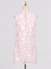Pink floral applique mini dress with ruffled details and a mock neck.