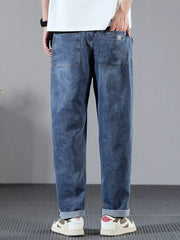 Men's blue denim jeans with wide leg and cuffed hems.