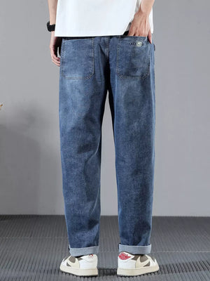 Men's blue denim jeans with wide leg and cuffed hems.
