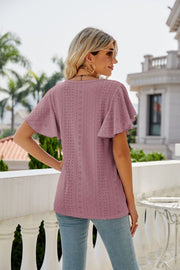 Mauve eyelet flounce sleeve crew neck top with allover geometric pattern.