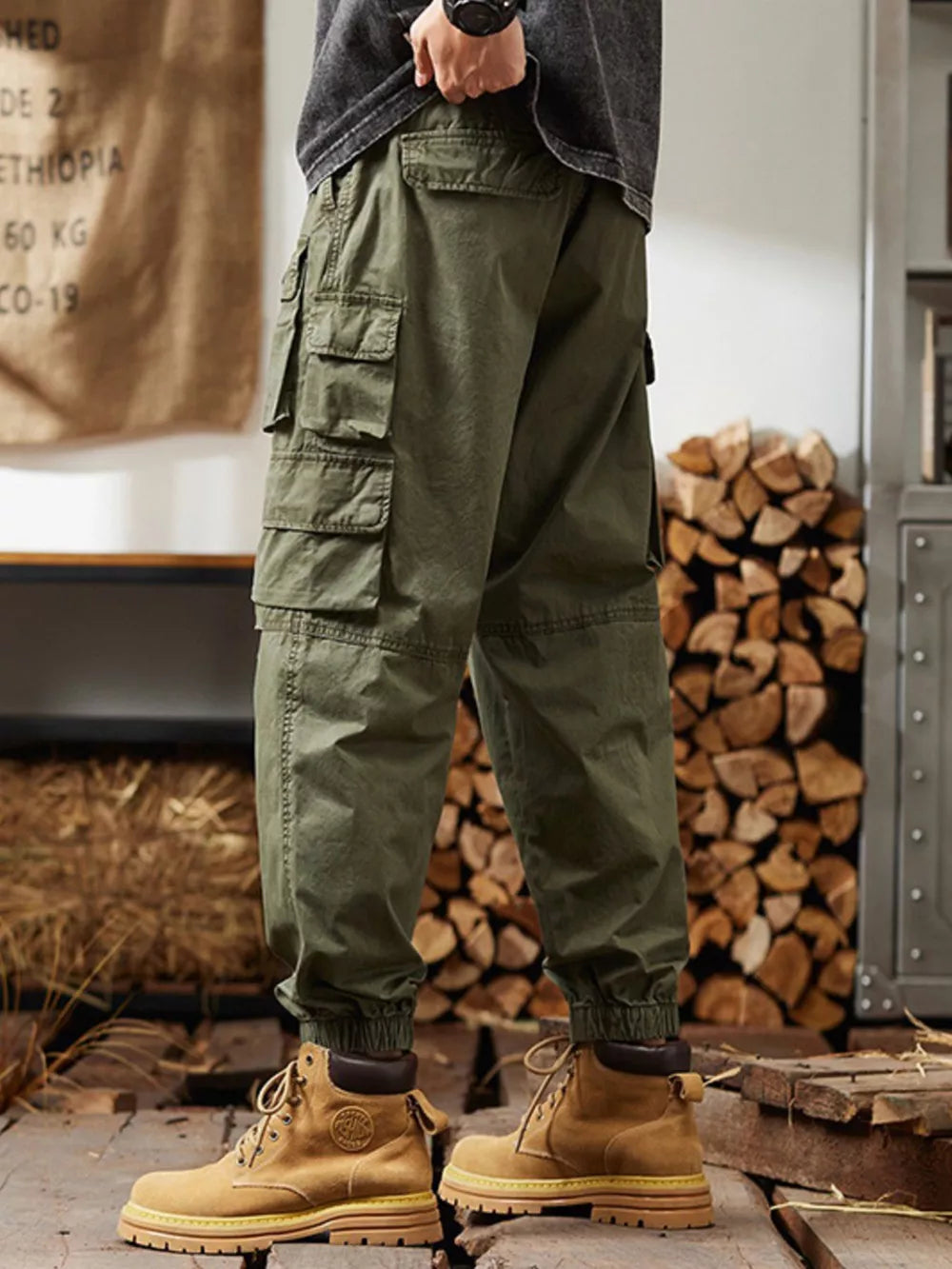 Military green relaxed fit cargo pants with multiple pockets and elastic cuffs.