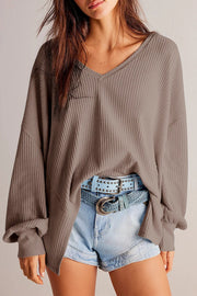 Waffle knit blouson sleeve top in mocha with V-neck and cuffed sleeves.