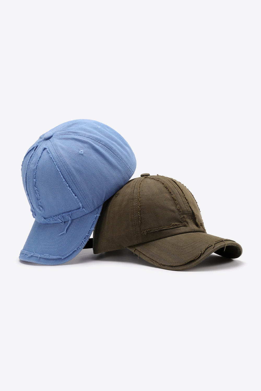 Raw edge denim baseball caps in Cobalt Blue and Army Green with distressed details.