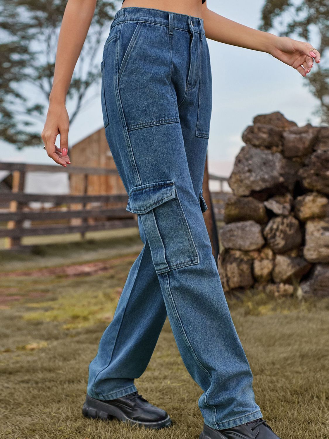Medium wash denim straight leg cargo pants with large side pockets.