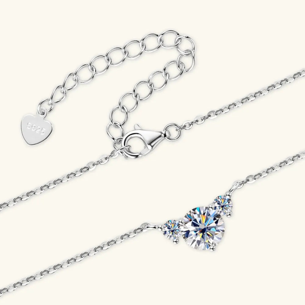 Silver necklace with a trio of sparkling diamonds and a heart-shaped 925 charm.