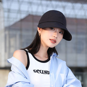 Black bucket hat with adjustable strap and wide brim for UV protection.