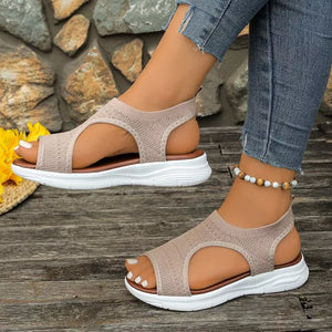 Beige knit open-toe platform sandals with white soles and a beaded anklet.