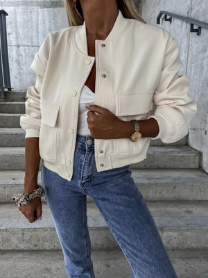 Beige faux leather bomber jacket with sculpted sleeves and snap front closure.